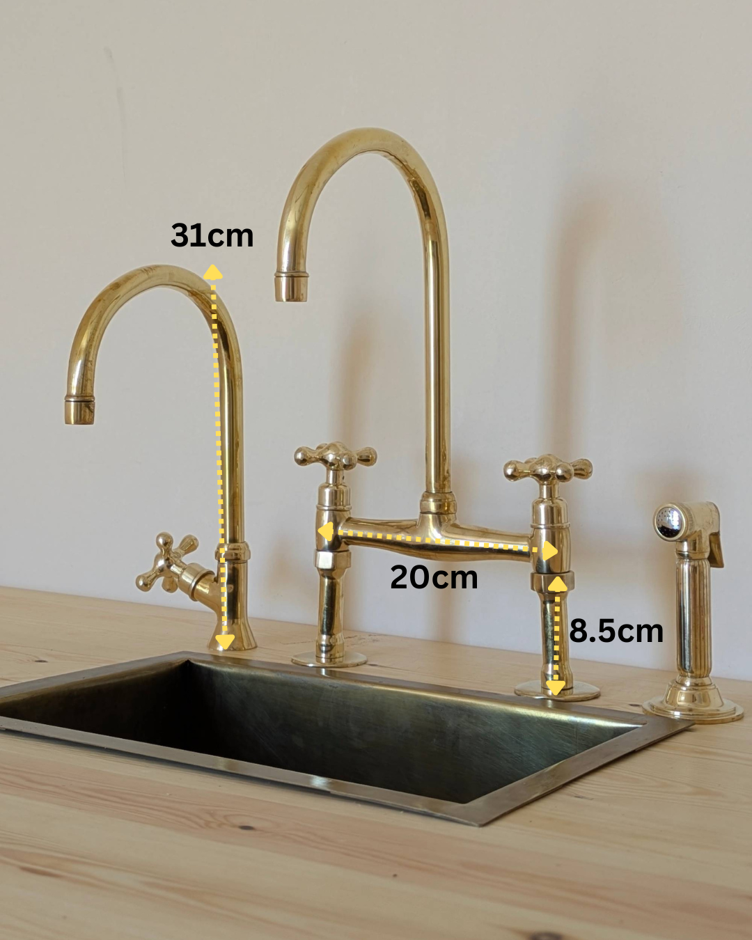 Unlacquered Brass Bridge Faucet With a Side Sprayer and a Separate Cold Water Faucet.