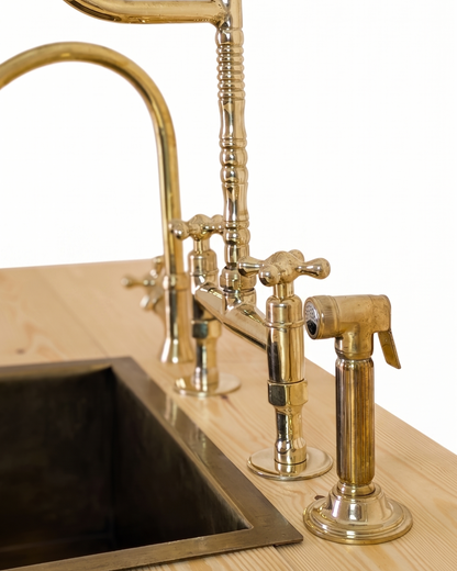 Unlacquered Brass Bridge Faucet  With a Side Sprayer and a Separate Cold Water Faucet.