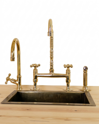Unlacquered Brass Bridge Faucet  With a Side Sprayer and a Separate Cold Water Faucet.