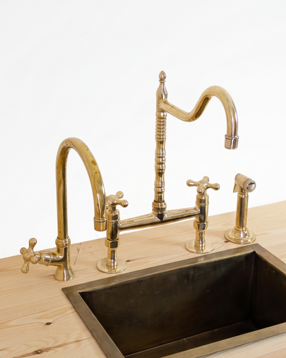 Unlacquered Brass Bridge Faucet  With a Side Sprayer and a Separate Cold Water Faucet.