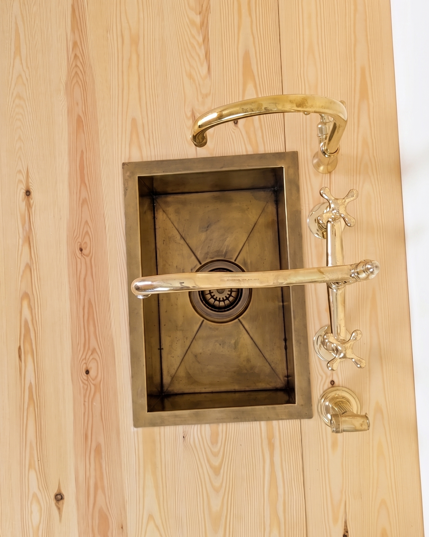 Unlacquered Brass Bridge Faucet  With a Side Sprayer and a Separate Cold Water Faucet.
