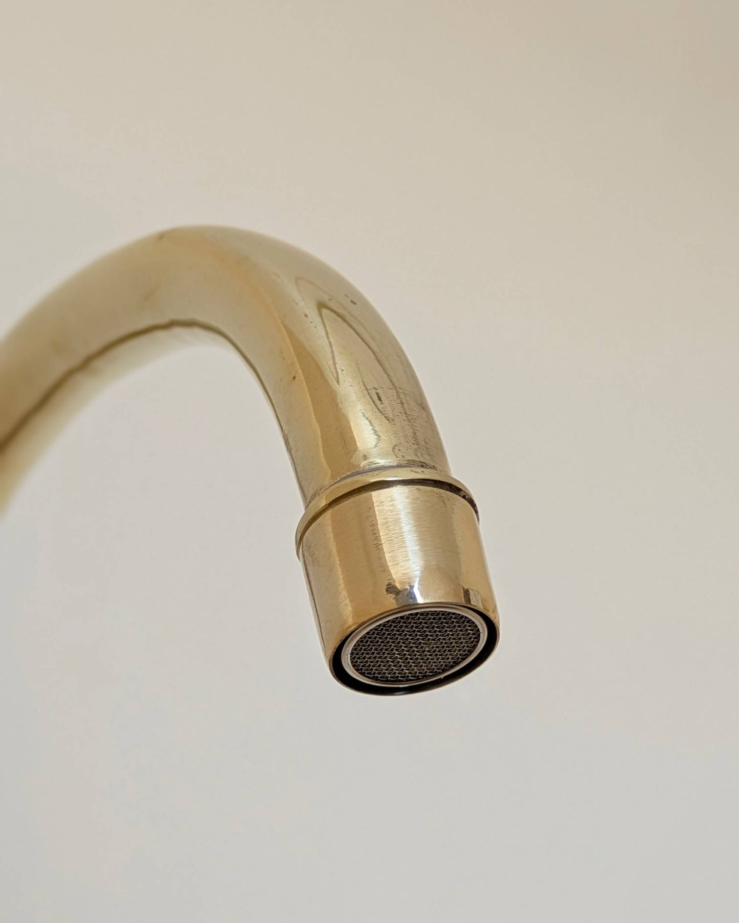 Unlacquered Brass Bridge Faucet  With a Side Sprayer and a Separate Cold Water Faucet.