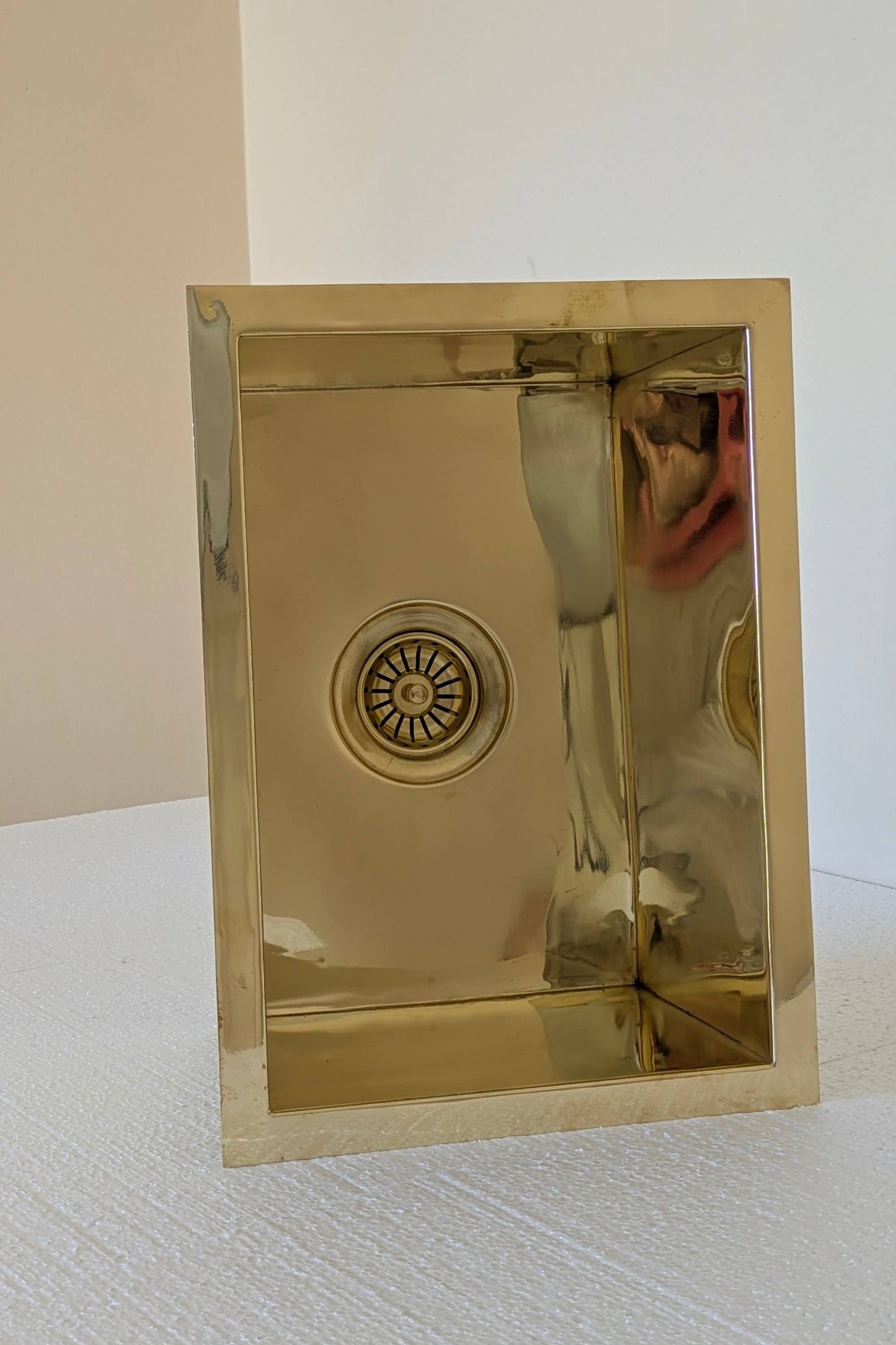 Undermount Single Bowl brass Sink: Rectangular Unlacquered Sink With It Drain Basket.